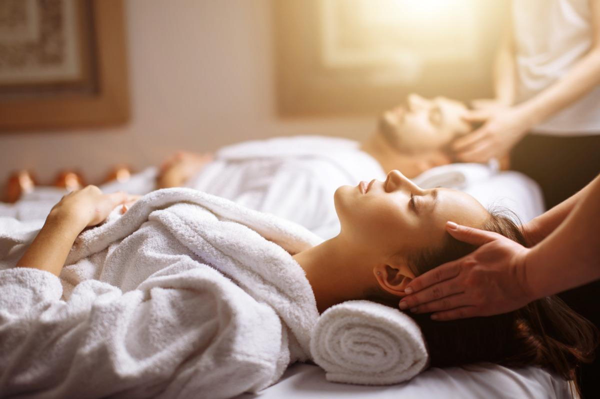 Professional Couple Massage treatment with essential oils in serene spa environment